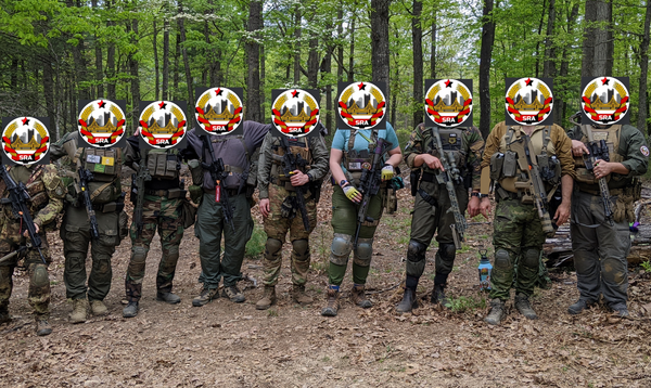 Comrades in kit holding rifles in the woods. All 9 participants have the Pittsburg SRA logo covering their faces.